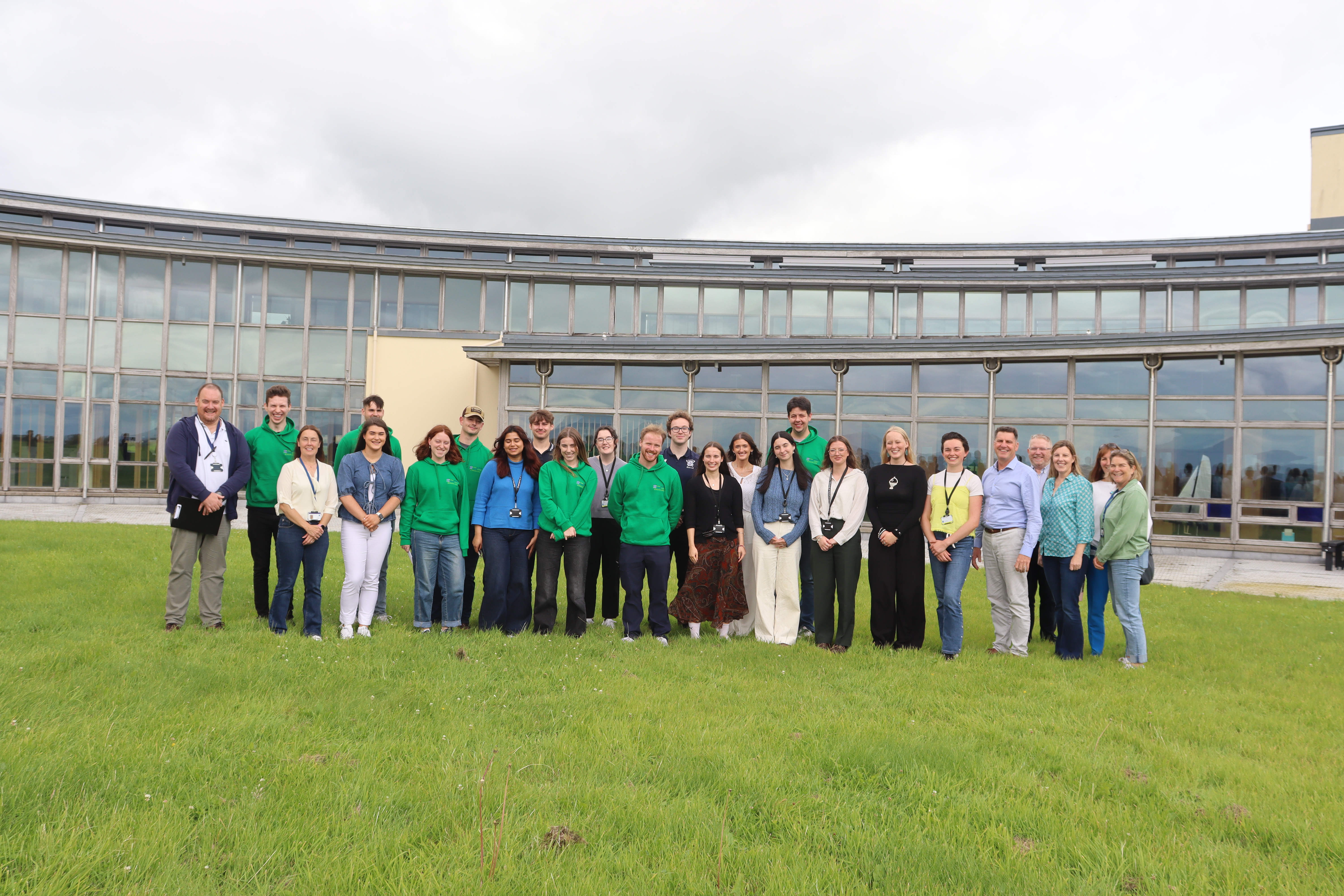 A group of Bursars from 2025 standing togeter with the organiser team near the Marine Institute HQ in Oranmore. 