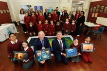 Minister Timmy Dooley, DCEE and Rick Officer, CEO, Marine Institute with school children and Explorers course materials